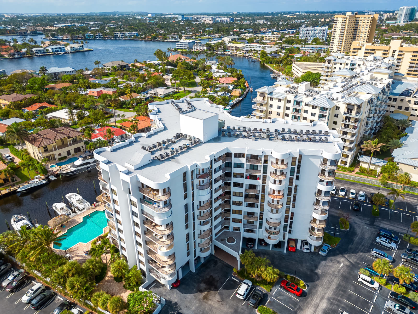 Aerial of a white multi-story condominium tower over the Intracoastal, reroofed by Campany Roofing